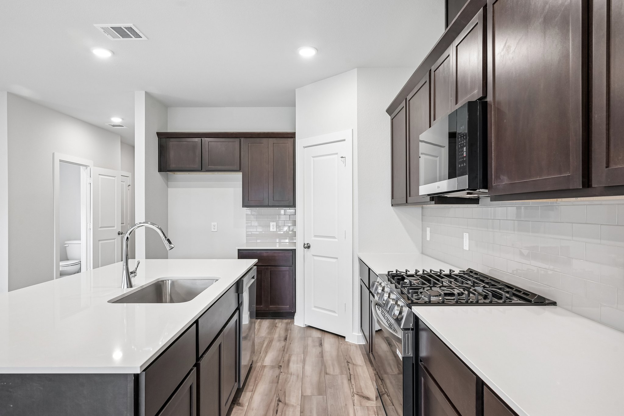 A kitchen with black cabinets.