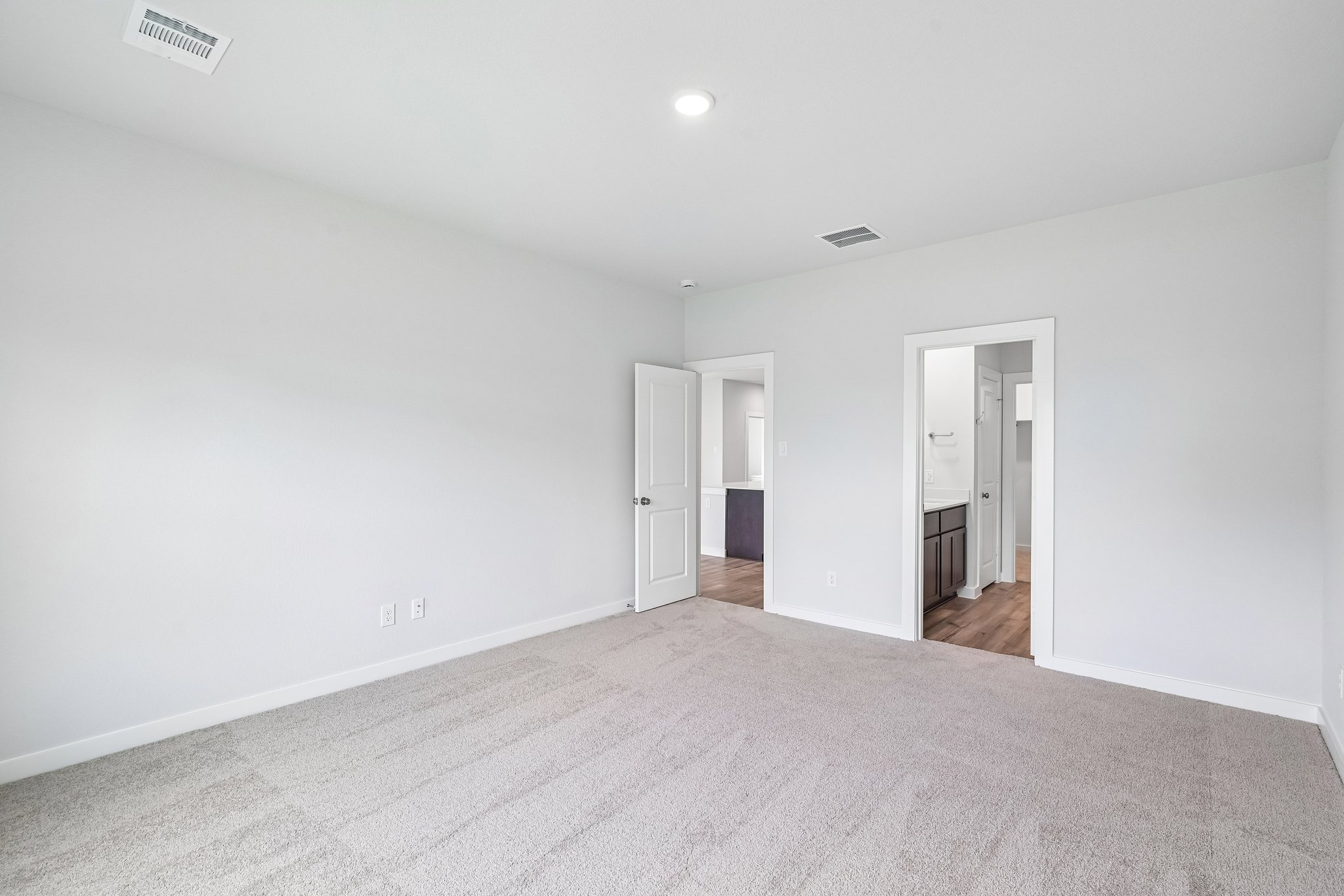 A hallway with white walls.
