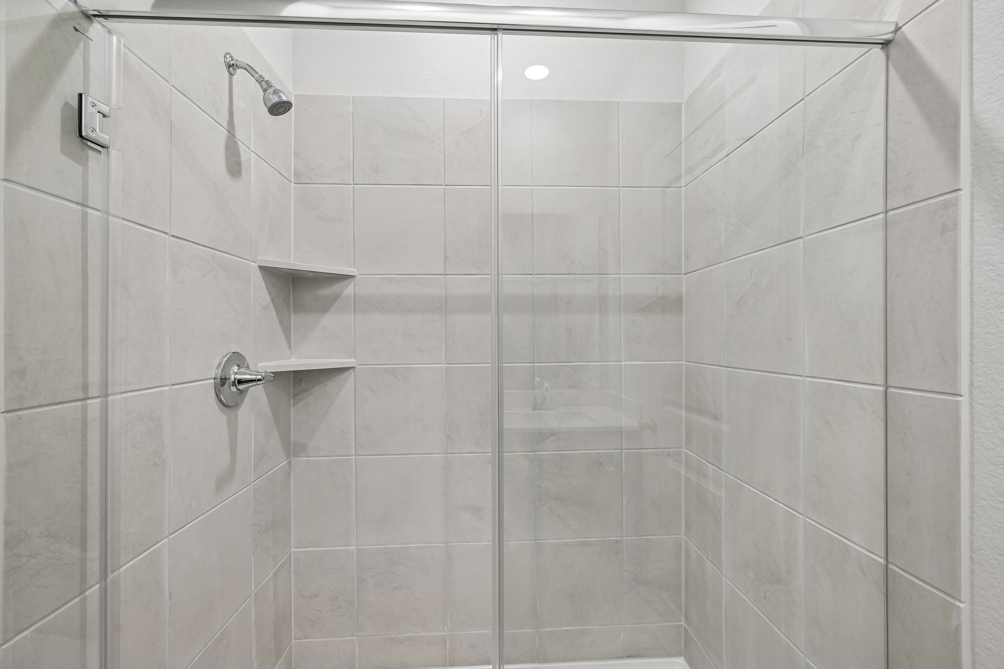 A shower with a glass door.