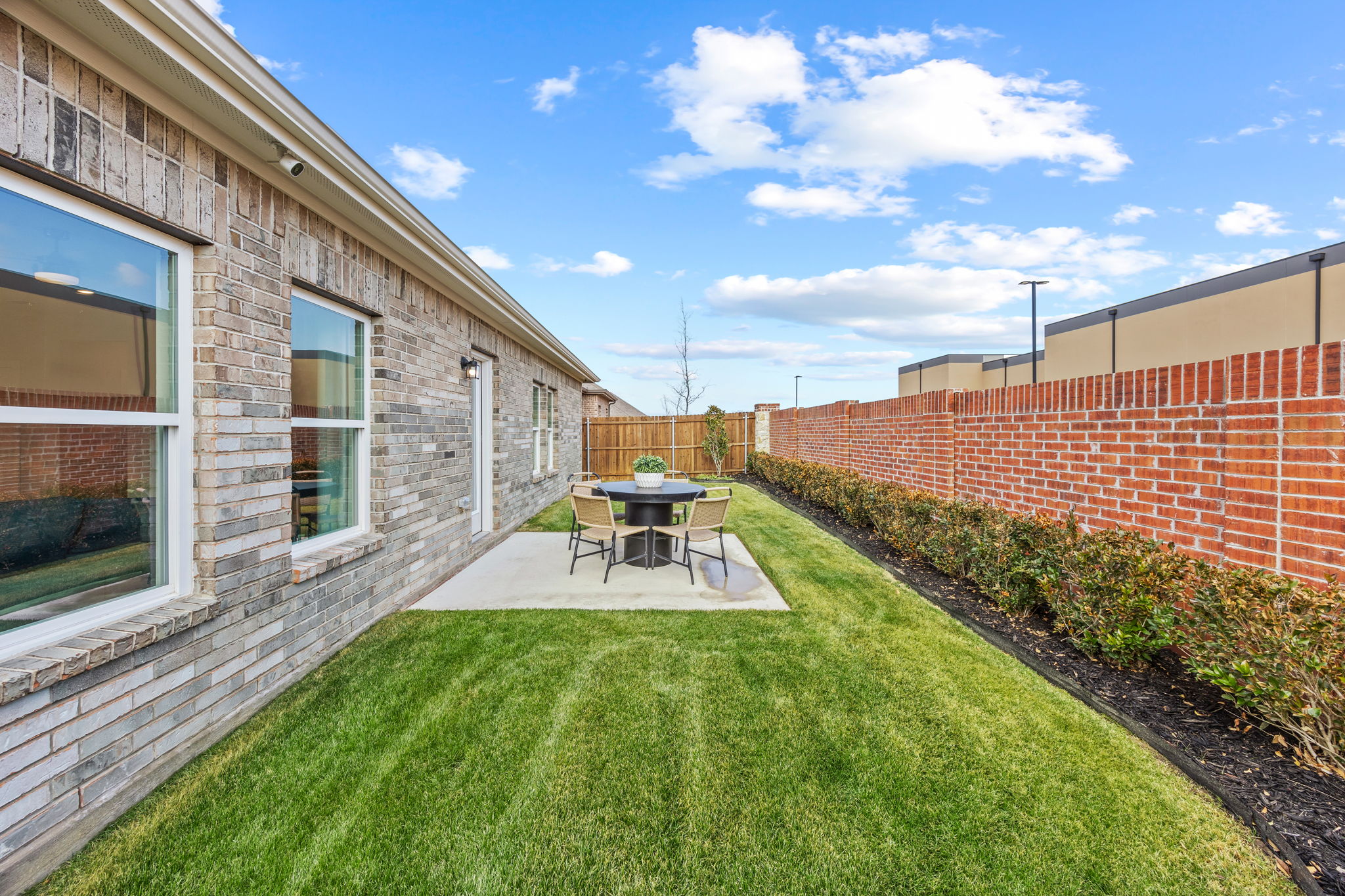 A backyard with a table and chairs.
