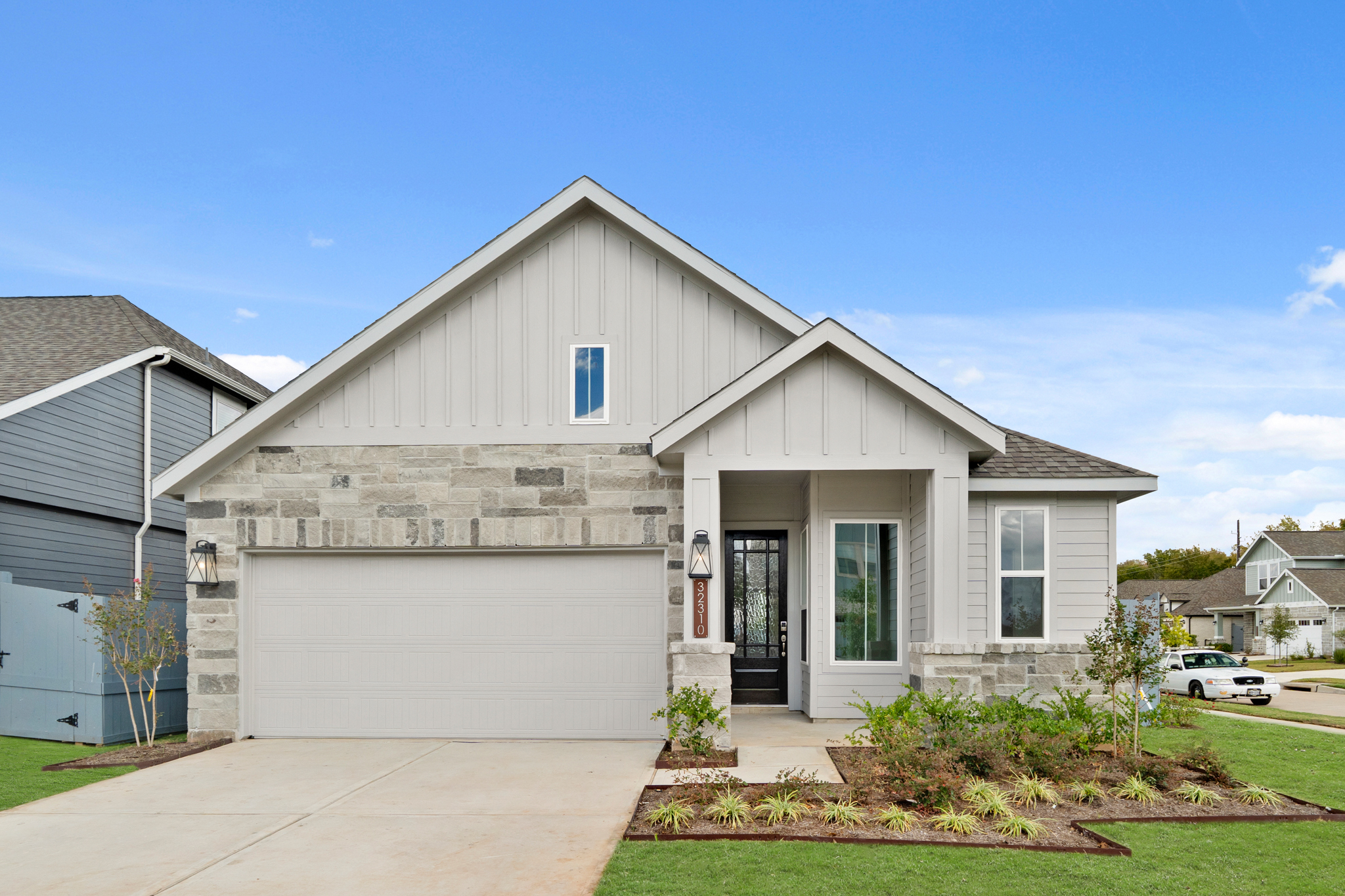 A white house with a garage.