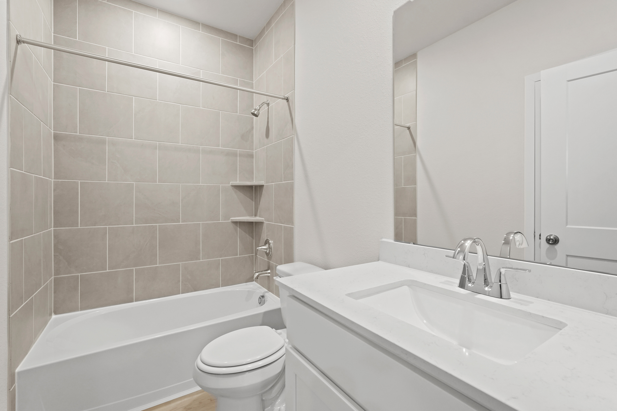 A bathroom with a tub sink and toilet.