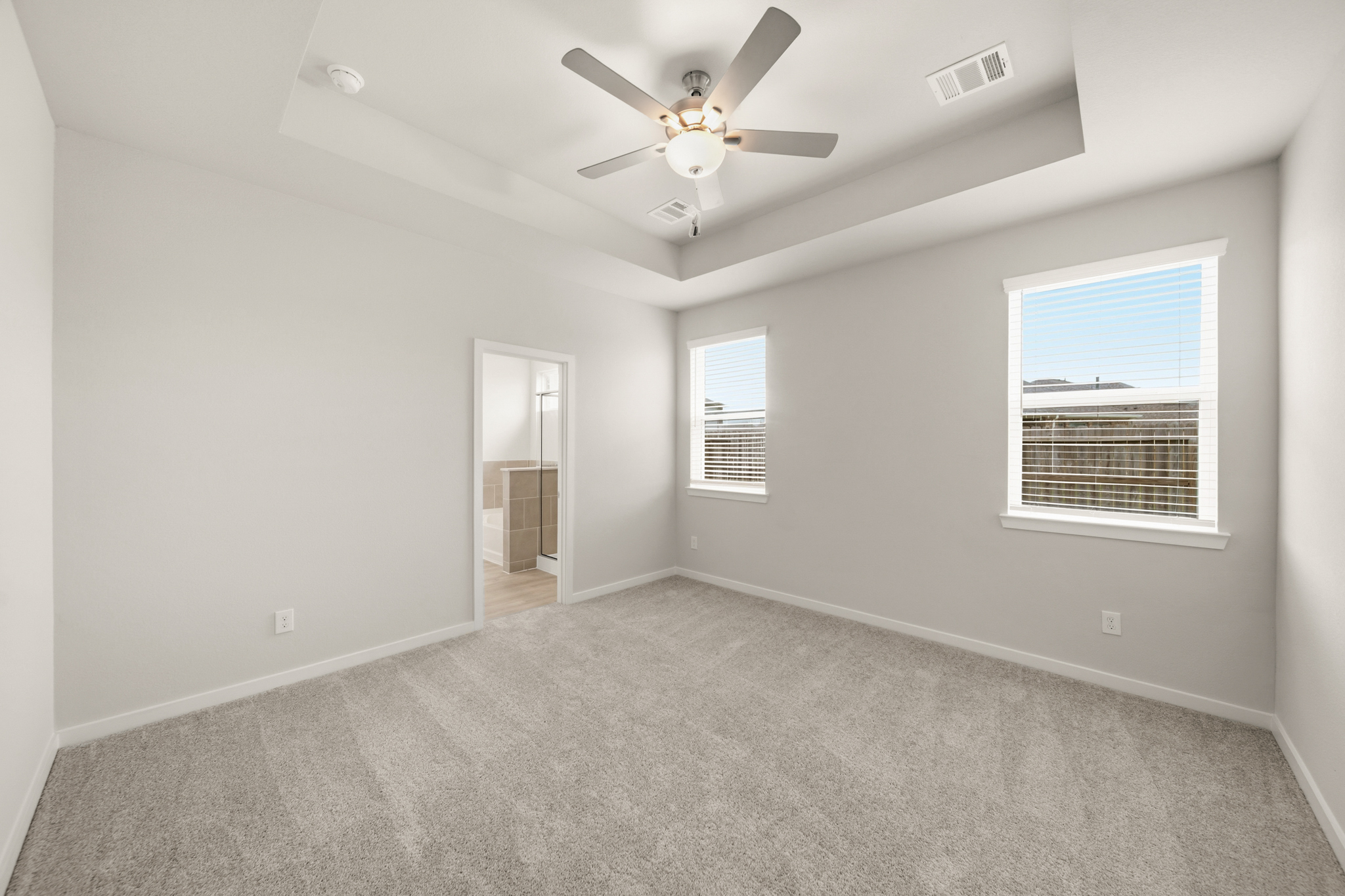 A room with a ceiling fan and a window.