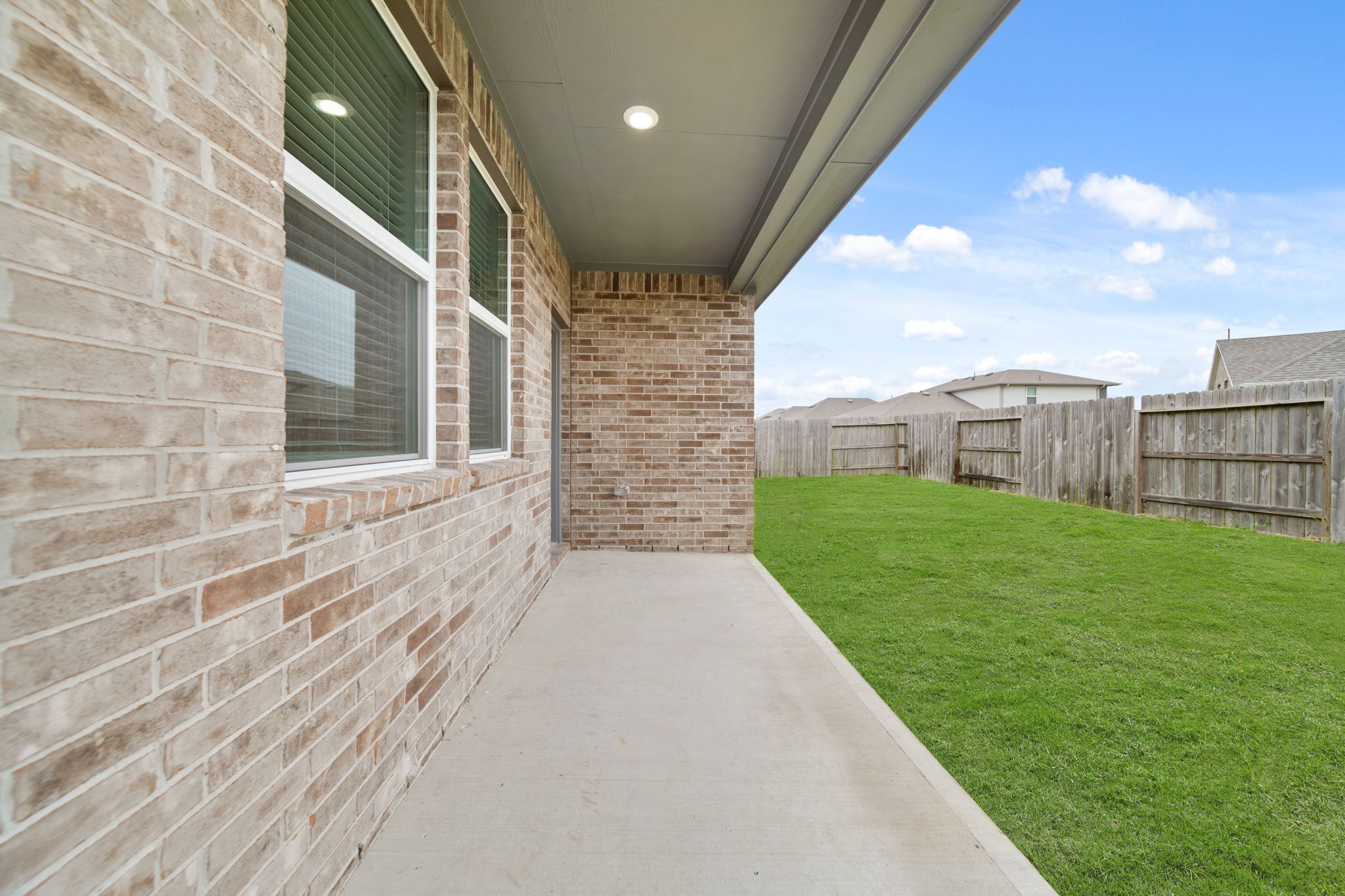 A walkway between brick walls.