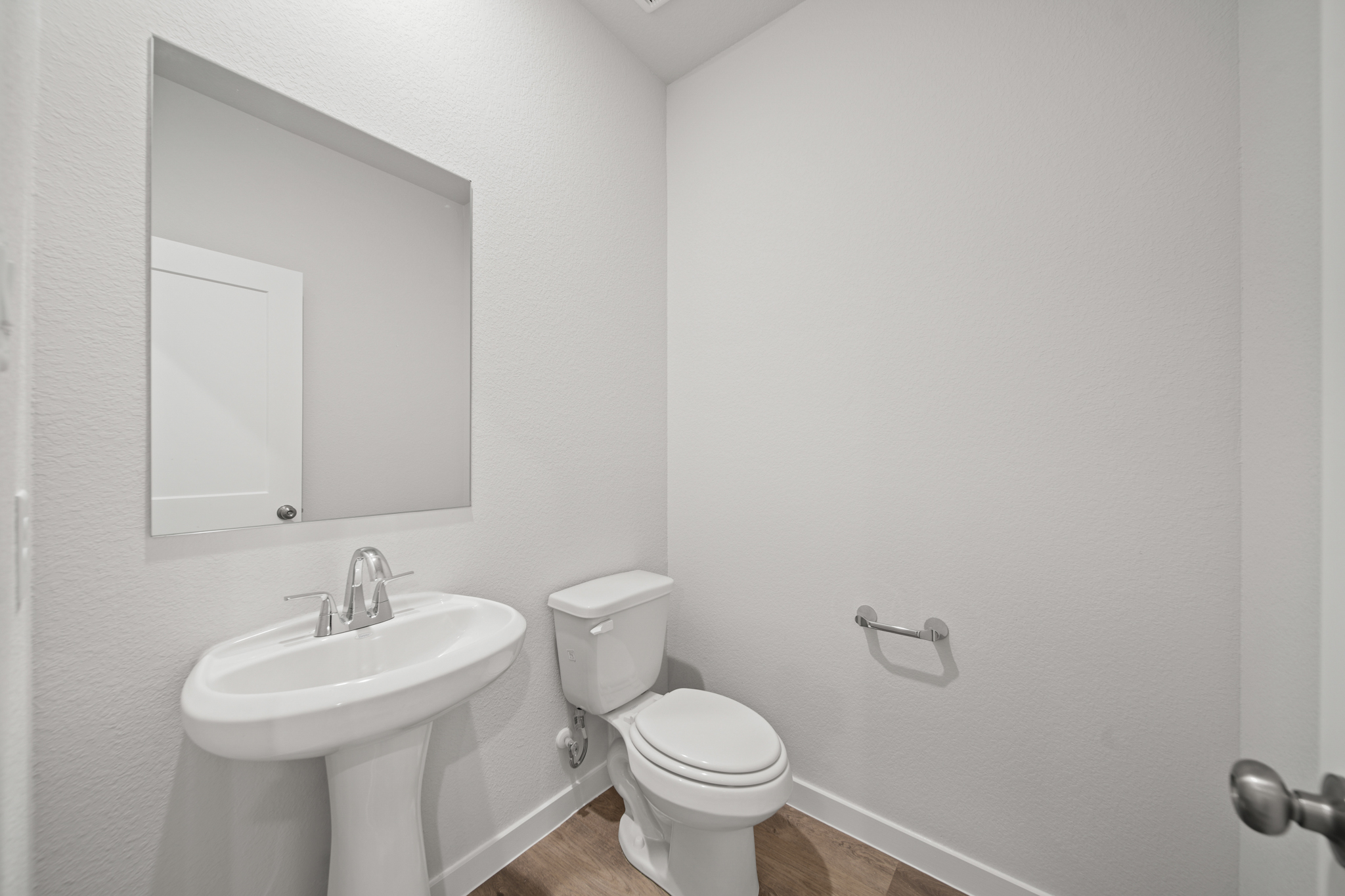 A bathroom with a toilet and sink.