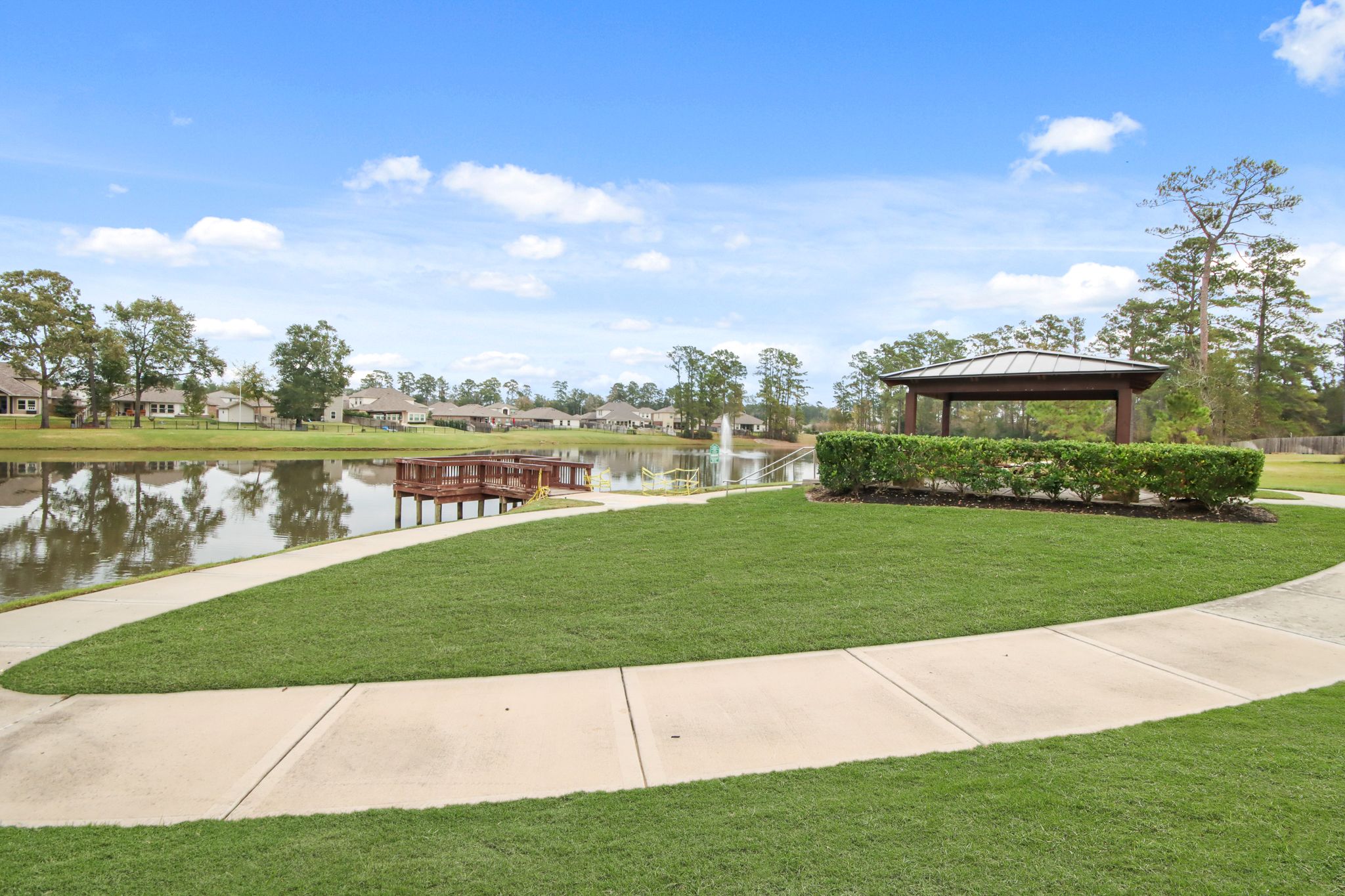 A pond with a building in the background.