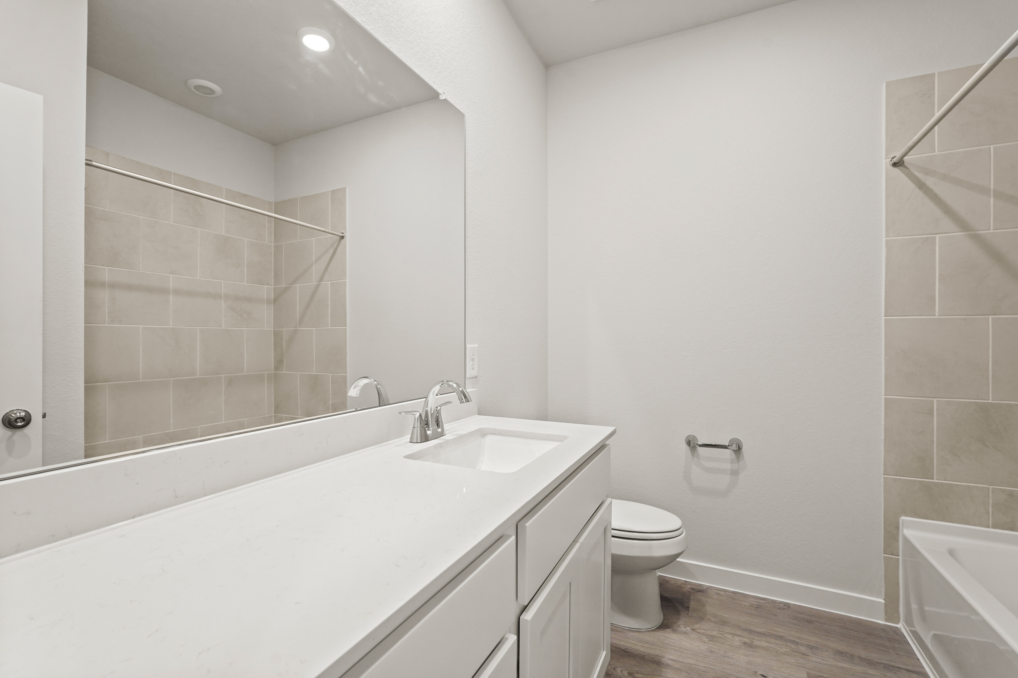 A bathroom with a tub sink and toilet.