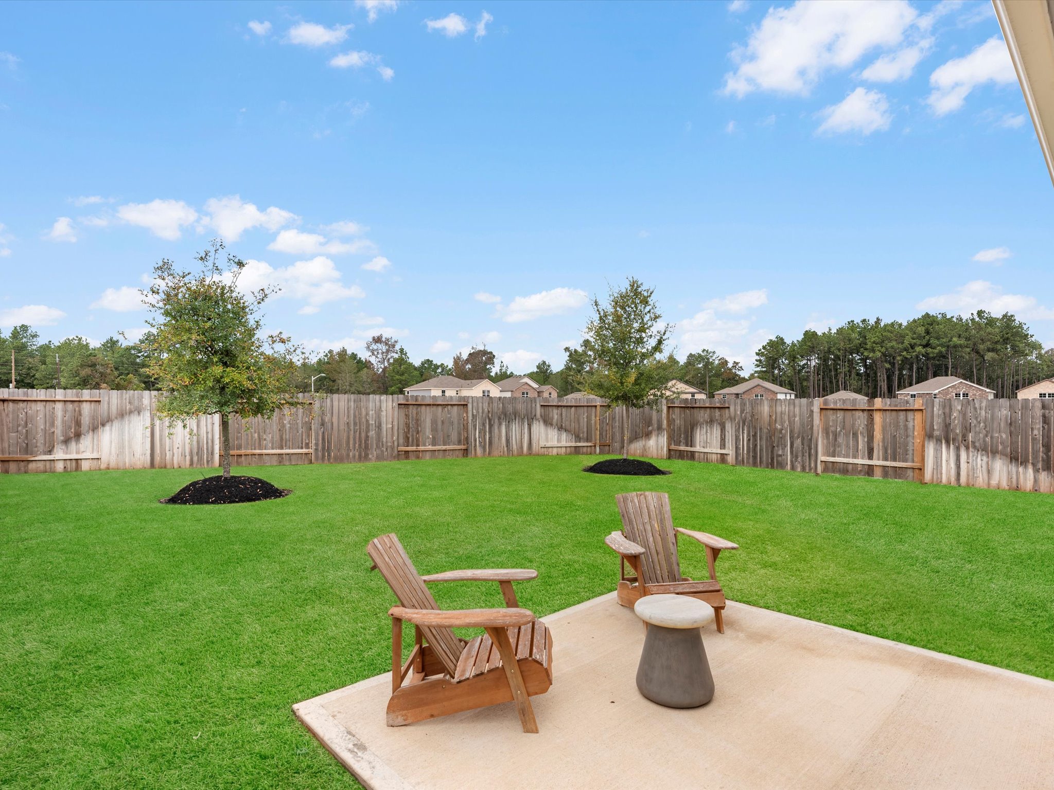 A couple of chairs on a patio.