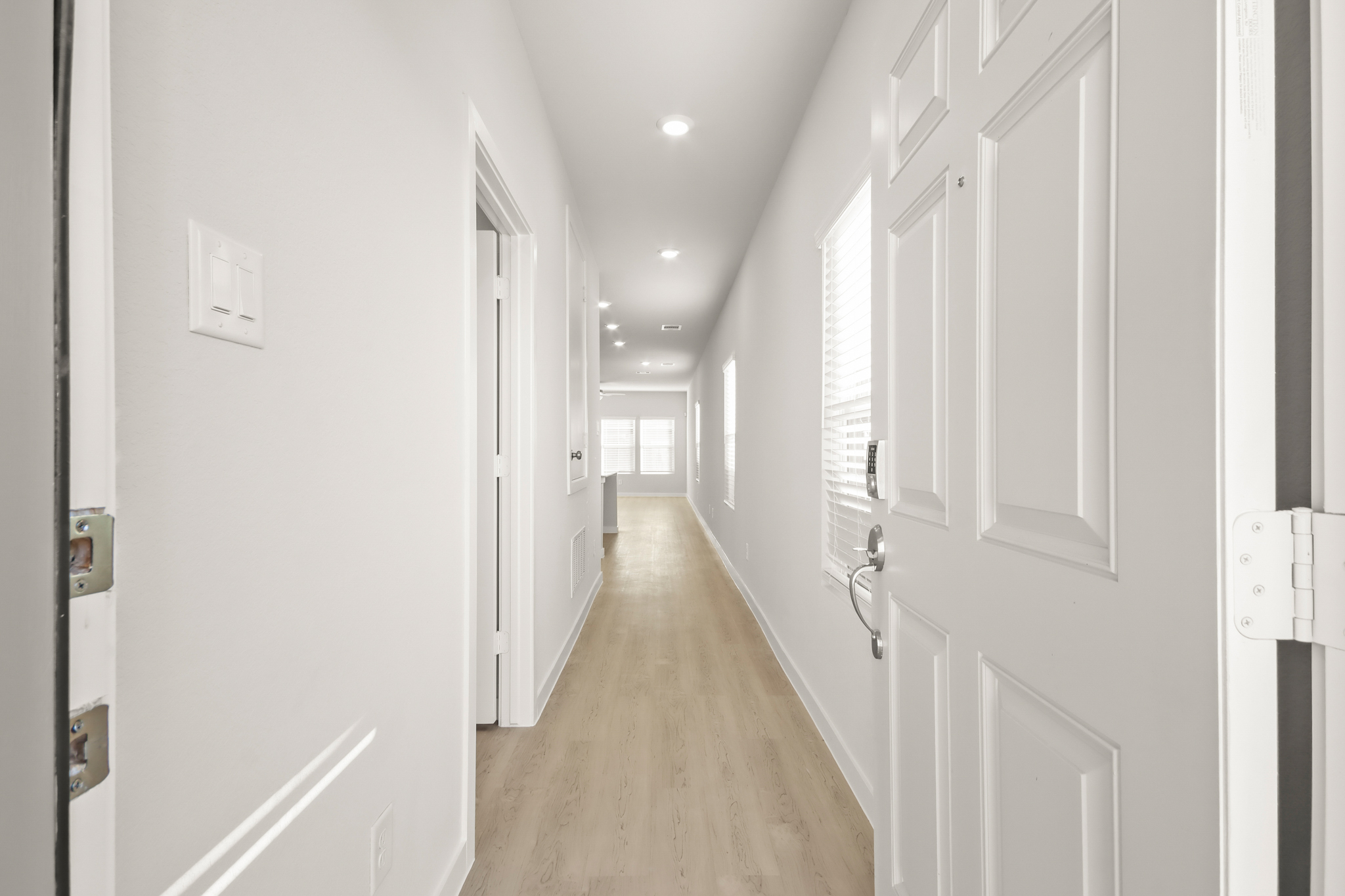 A hallway with white doors.