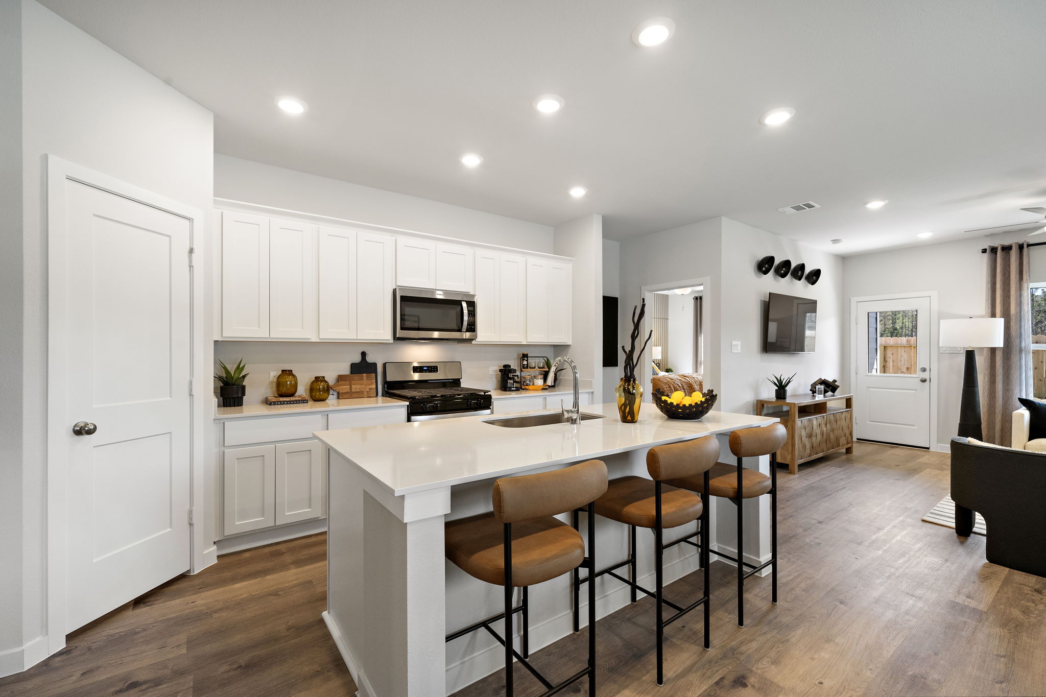 A kitchen with white cabinets.