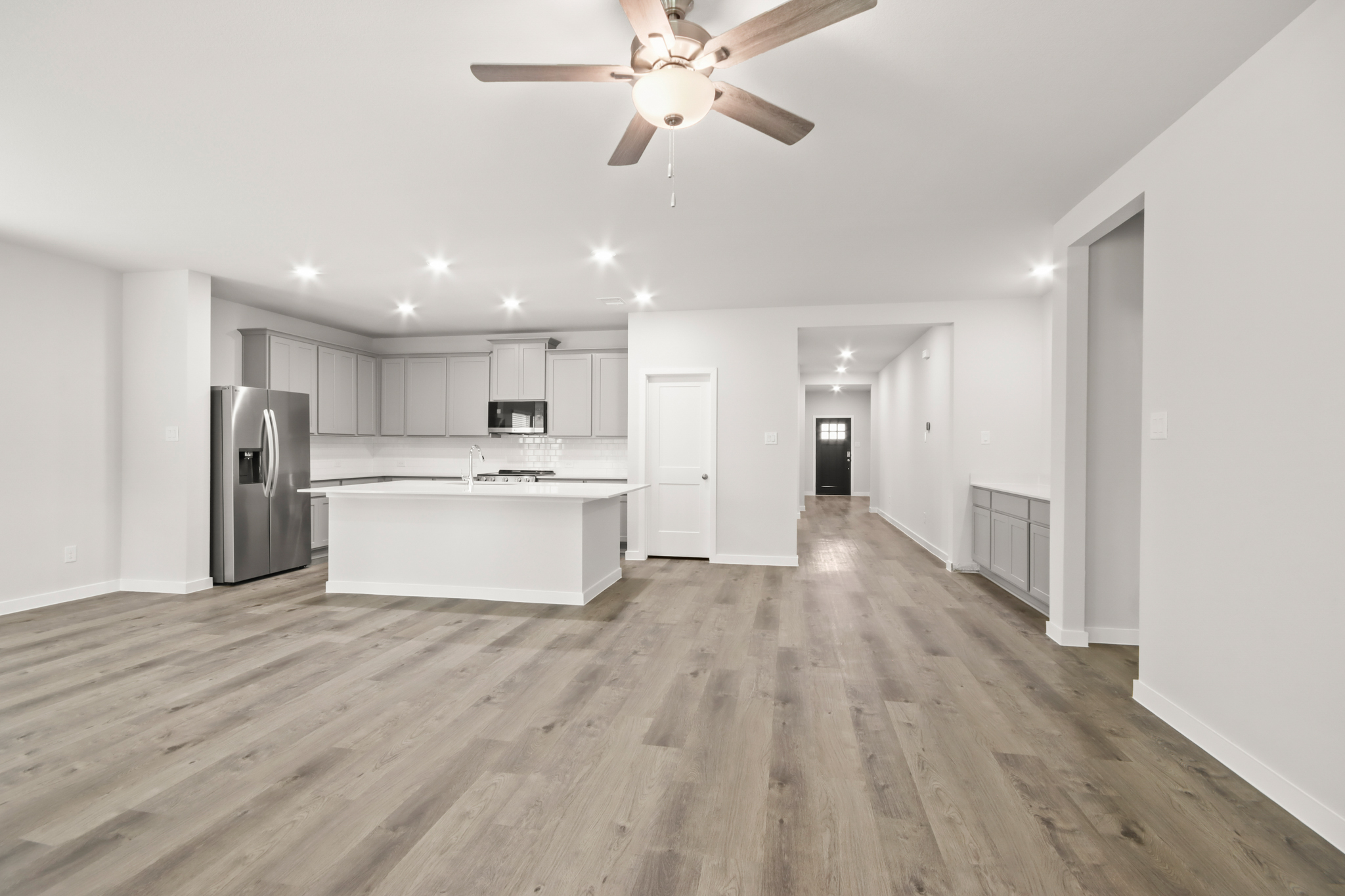 A kitchen with white cabinets.