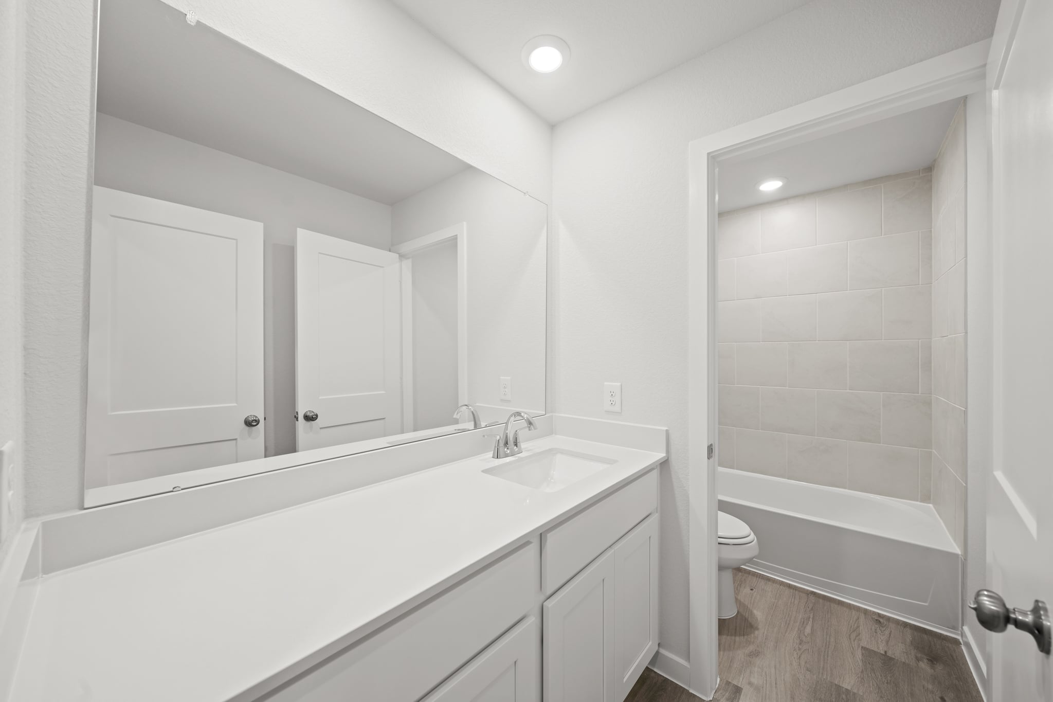 A bathroom with a tub sink and toilet.