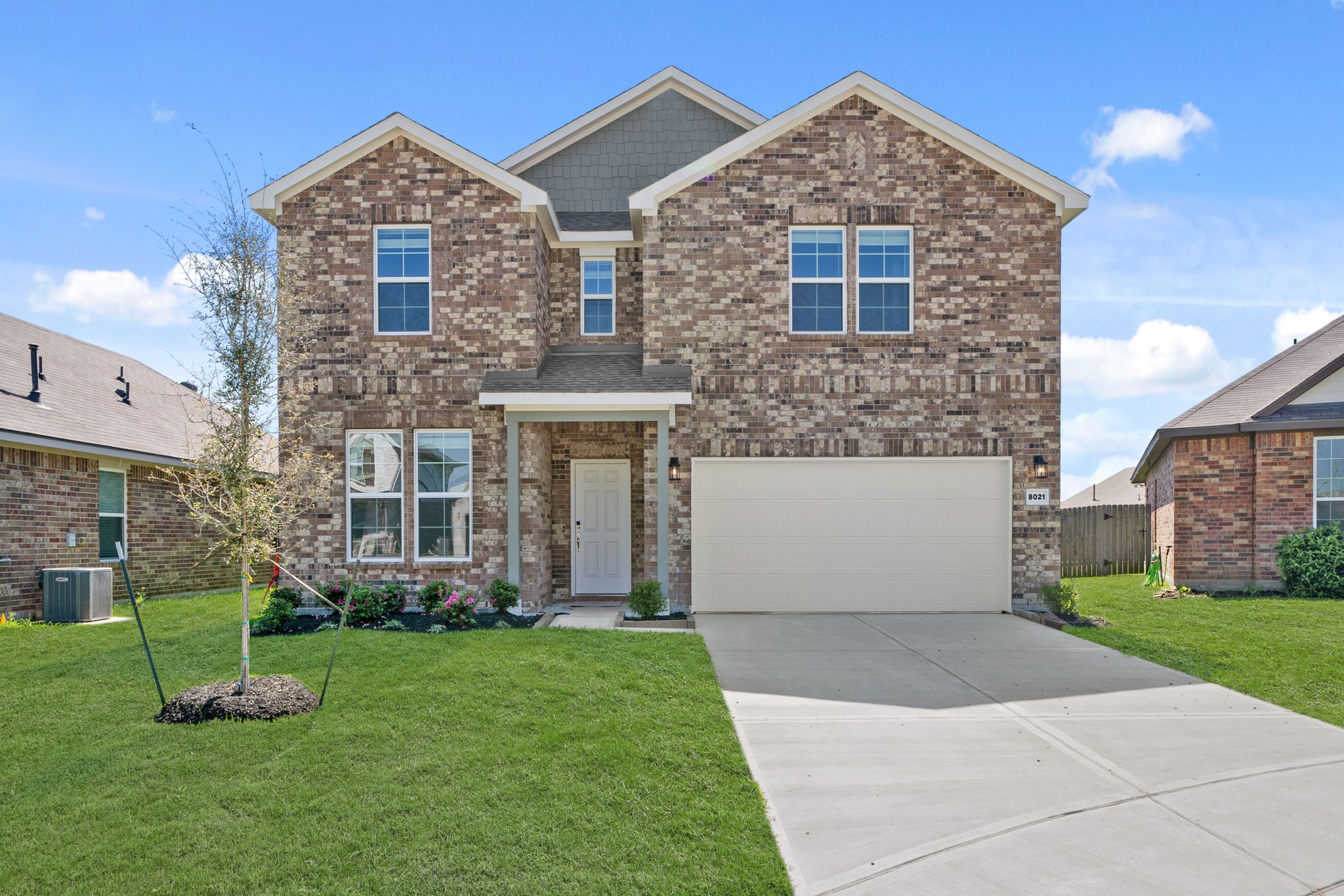A brick house with a driveway.