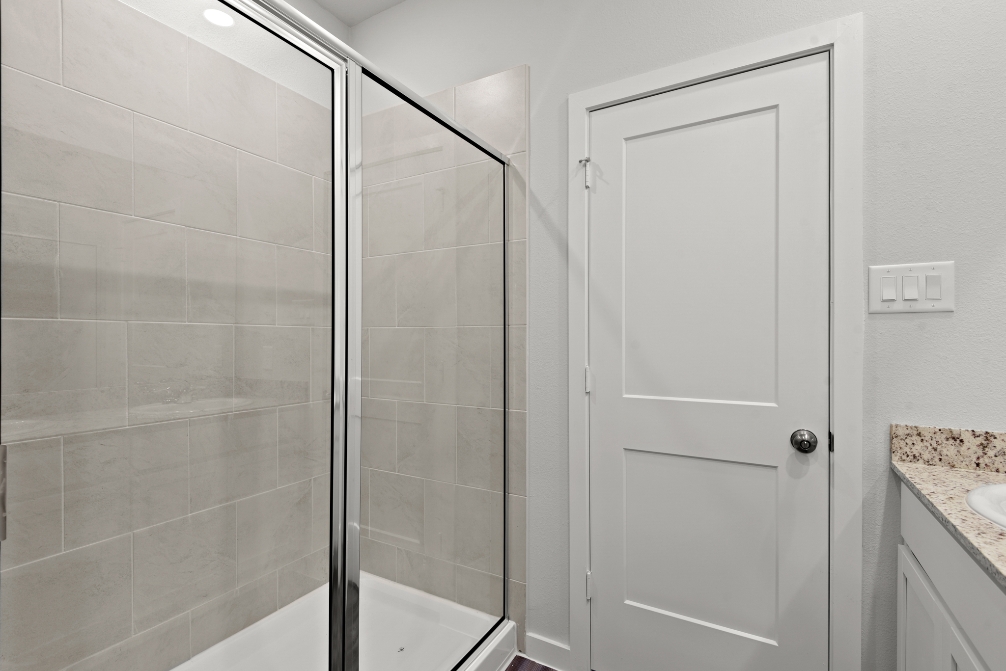 A bathroom with a glass shower.