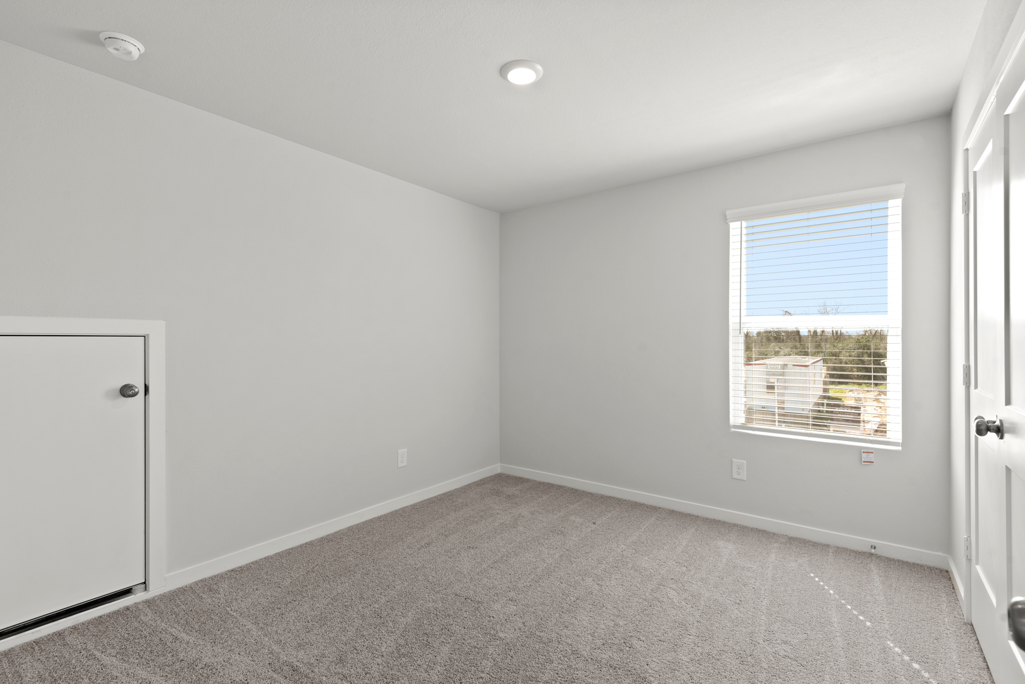 A room with a window and a door.