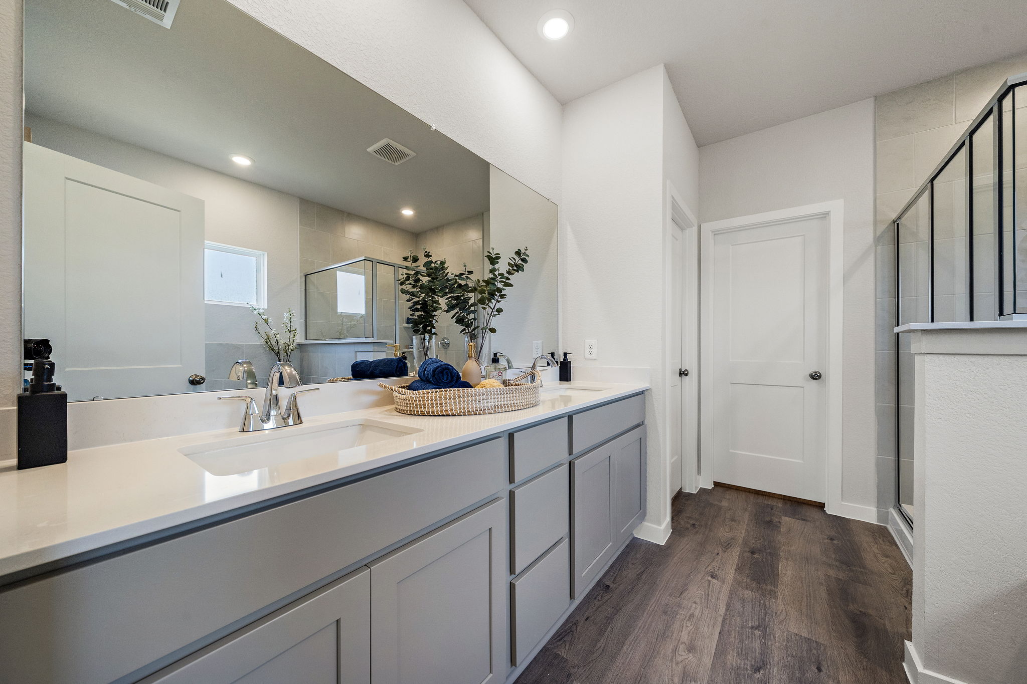A bathroom with a large mirror.