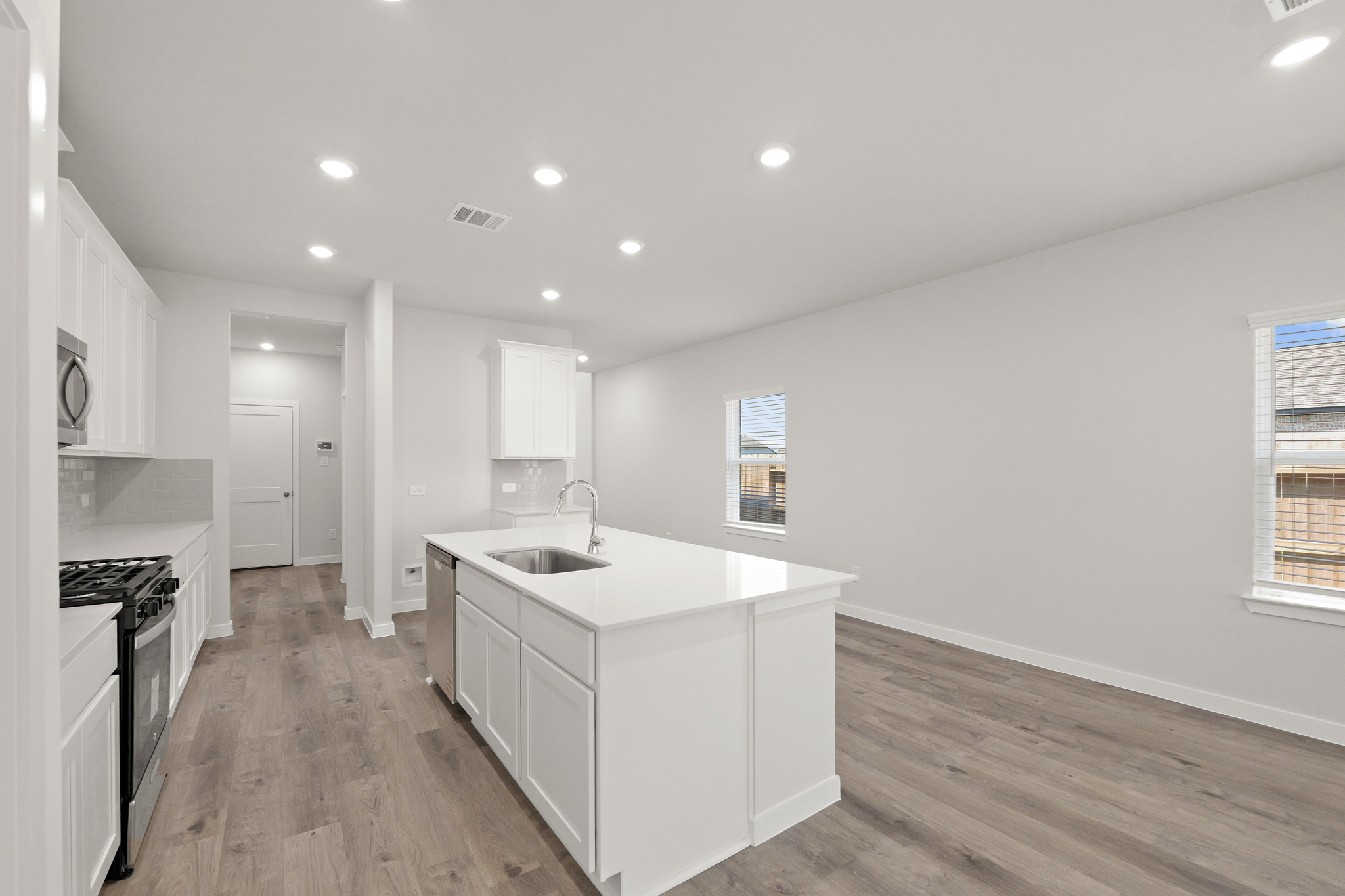 A kitchen with white cabinets.
