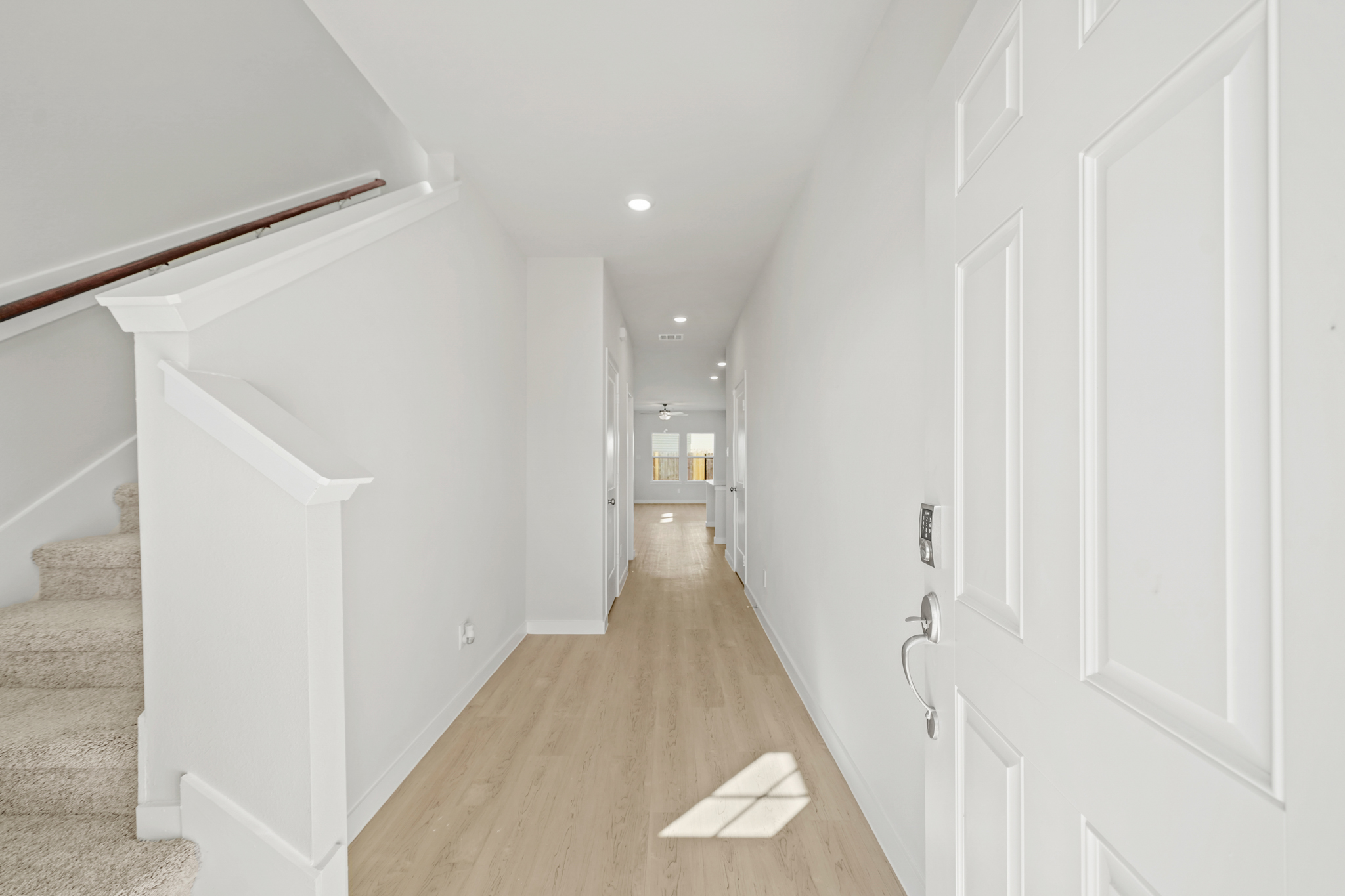 A hallway with white doors.