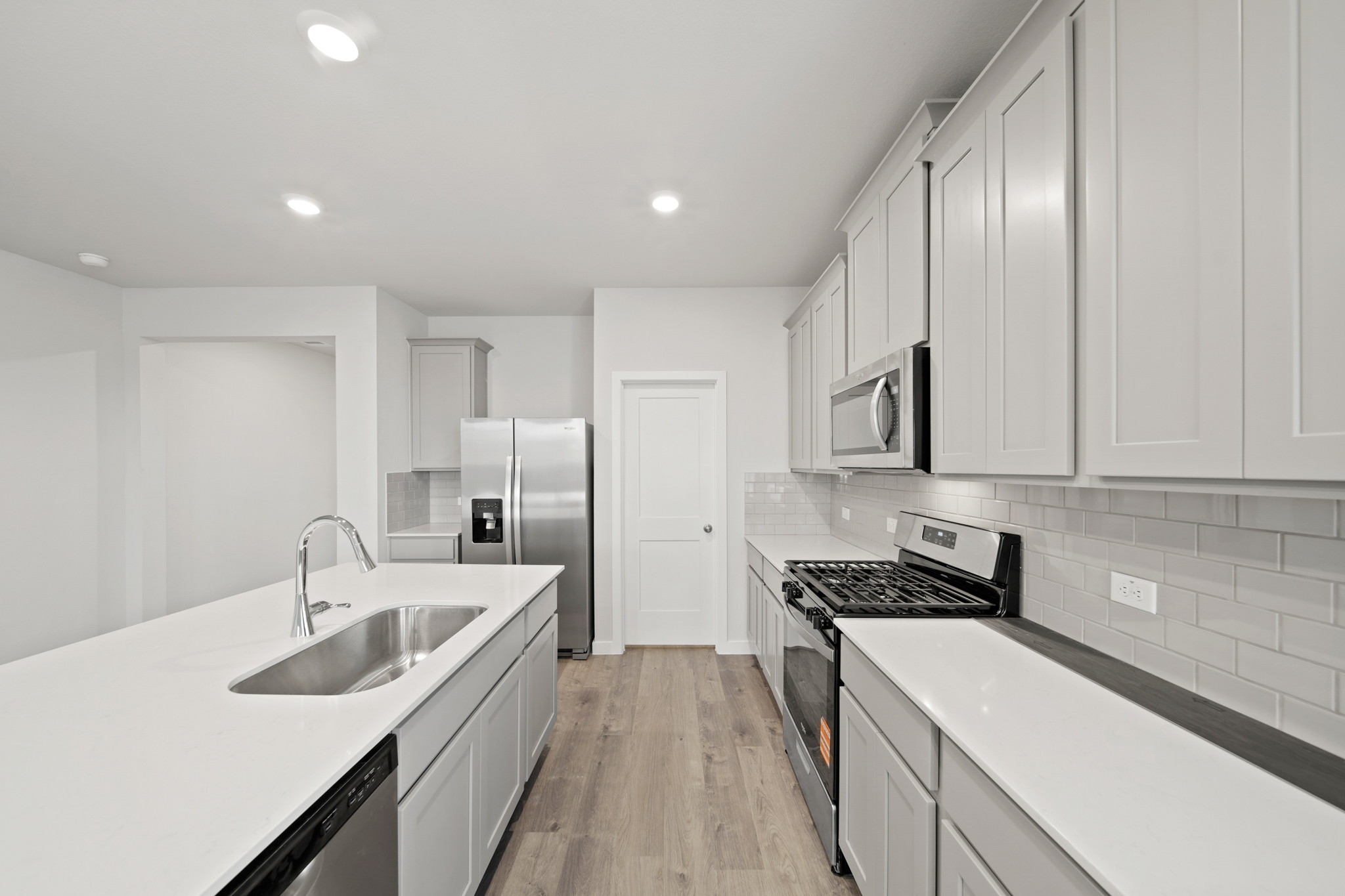 A kitchen with white cabinets.