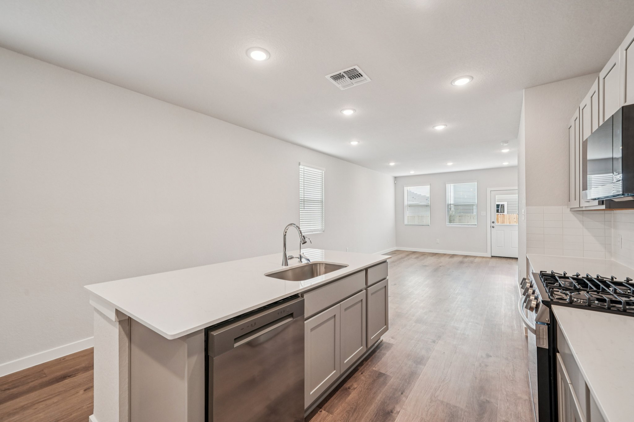 A kitchen with white cabinets.