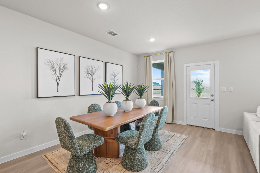 A room with a table and chairs.