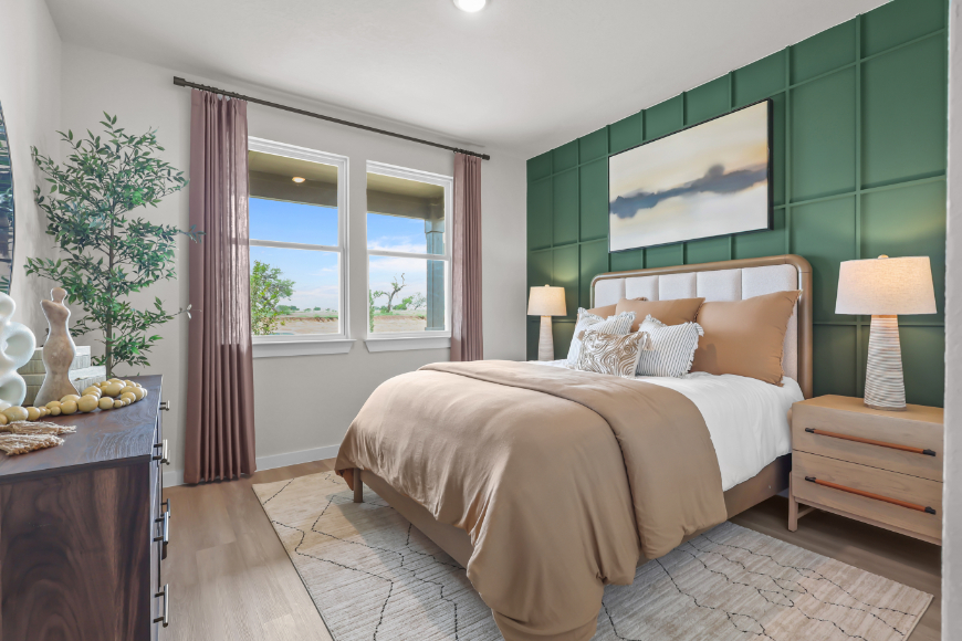 A bedroom with a large window.