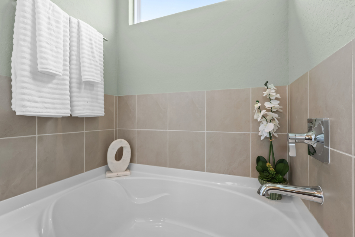 A bathroom with a bathtub and towels.