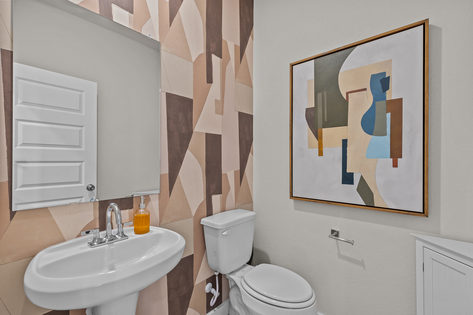 A bathroom with a picture on the wall.