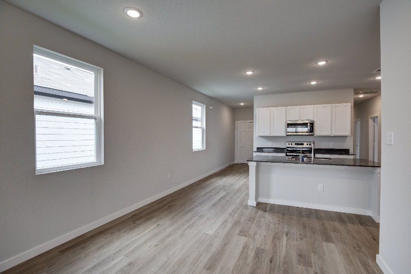 A kitchen with white cabinets.