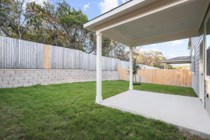 A house with a fence and grass.