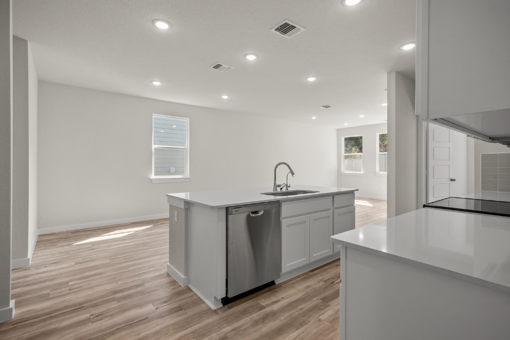 A kitchen with white cabinets.