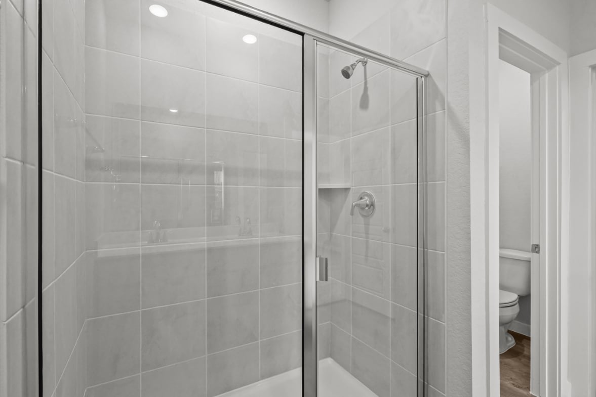 A shower with a glass door.