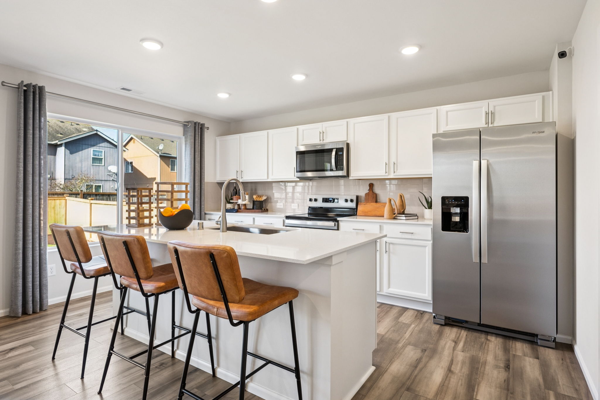 A kitchen with a table and chairs.