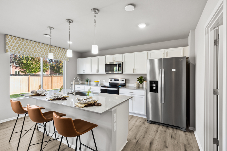 A kitchen with white cabinets.