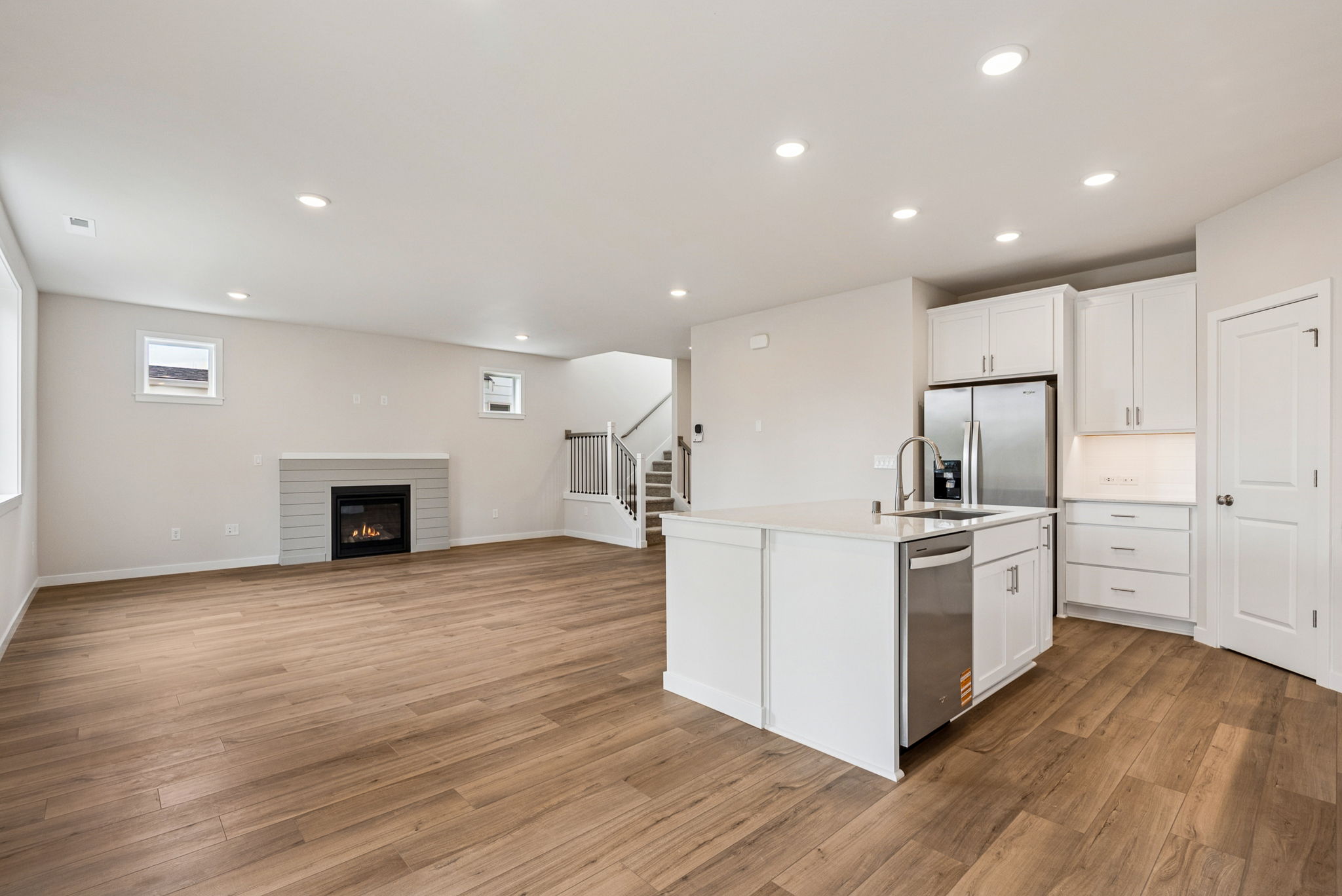 A kitchen with white cabinets.