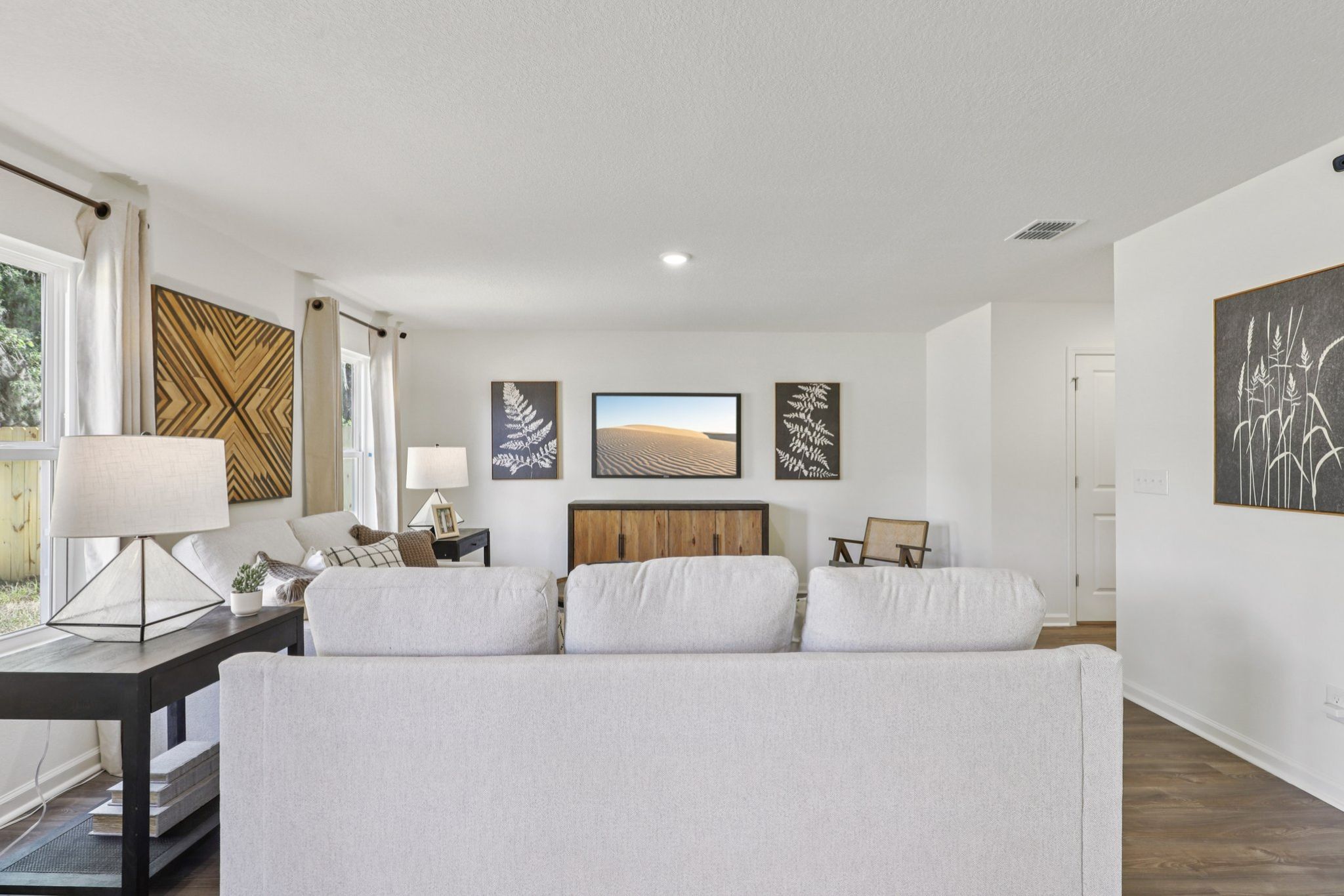 A large white living room with a large white couch.