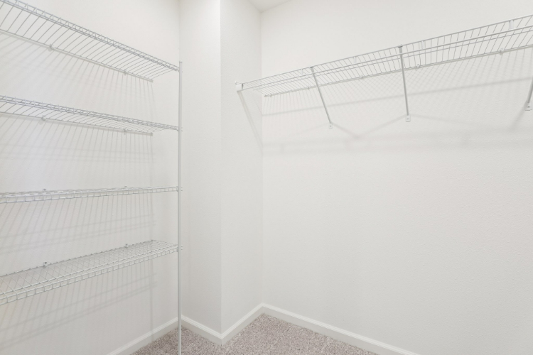 A white room with a metal railing.