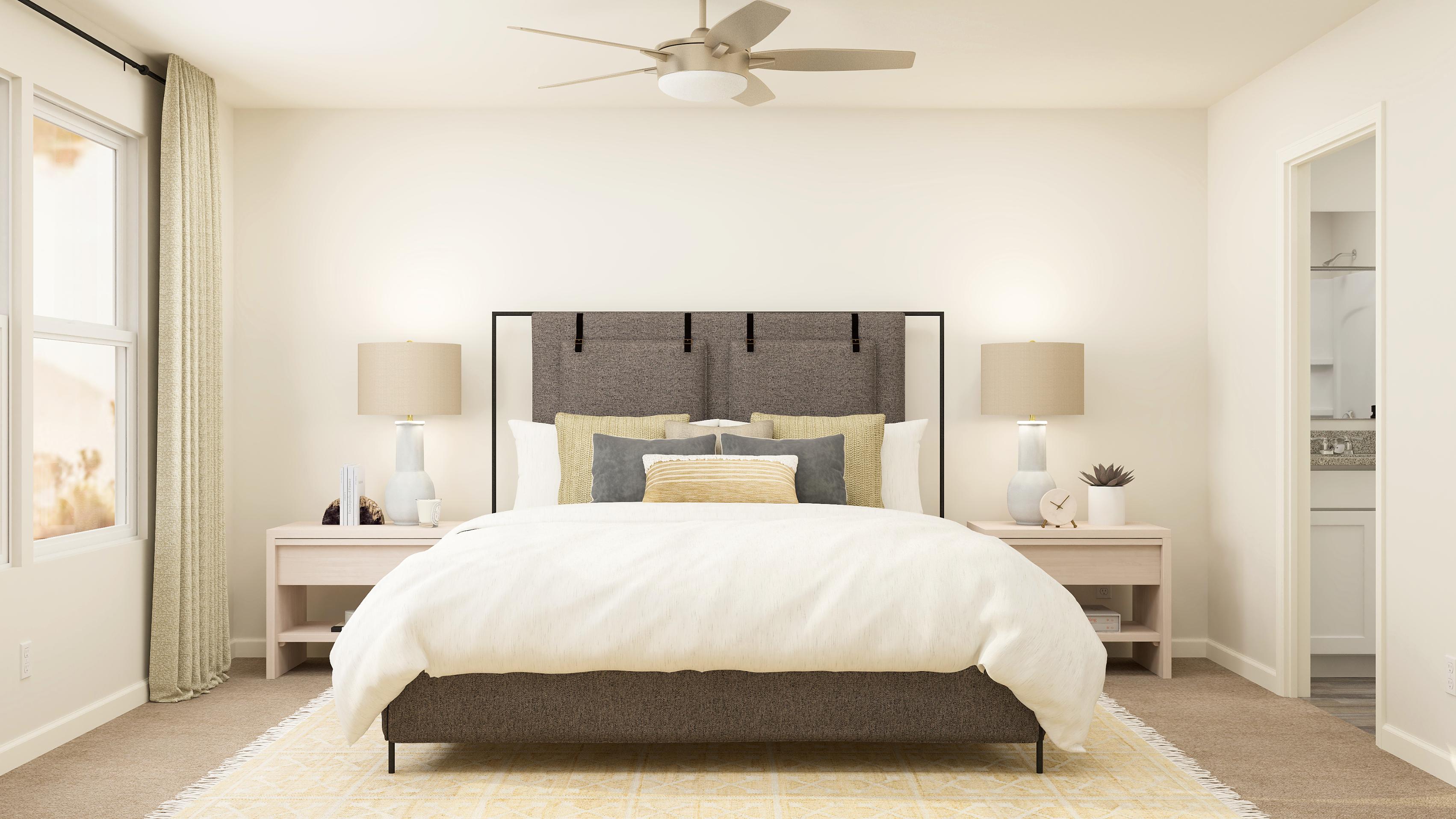 A bedroom with a bed and lamps.