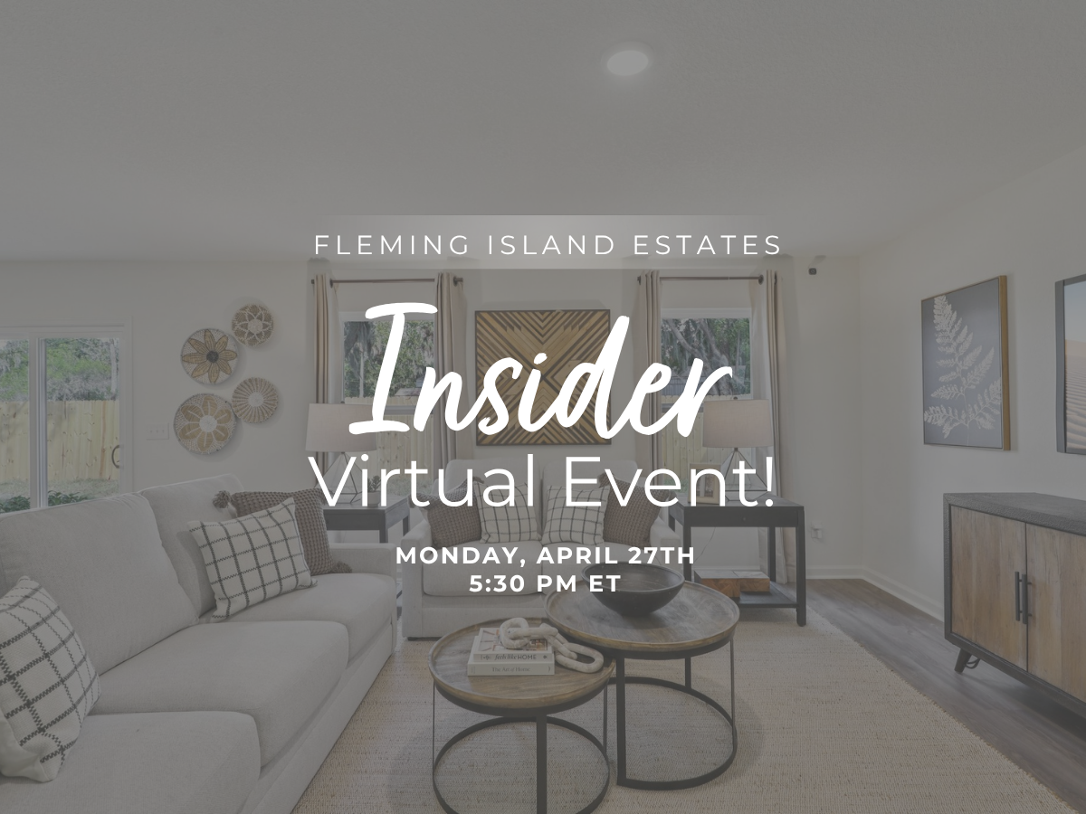 A room with a couch and a table with a window with a sign.