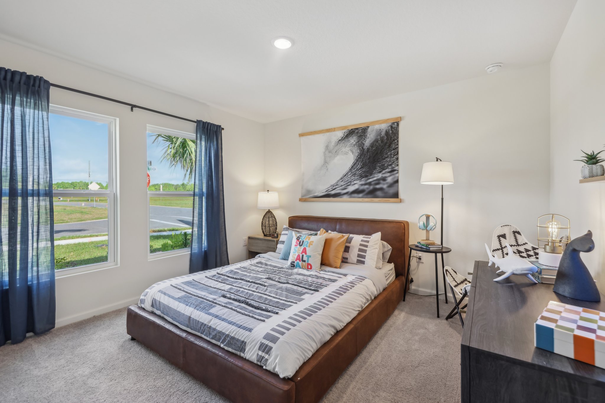 A bedroom with a large window.