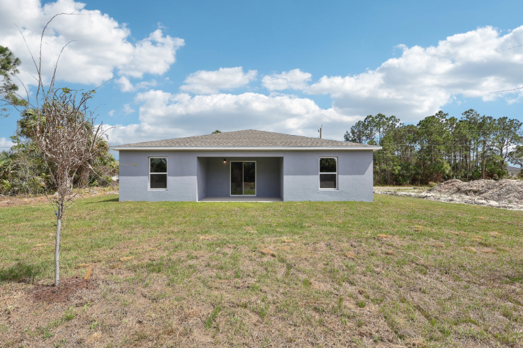 A white house in a field.