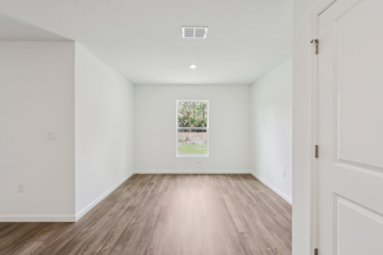A room with white walls and a wood floor.