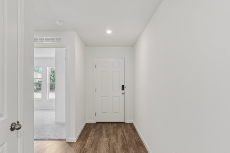 A hallway with white doors.