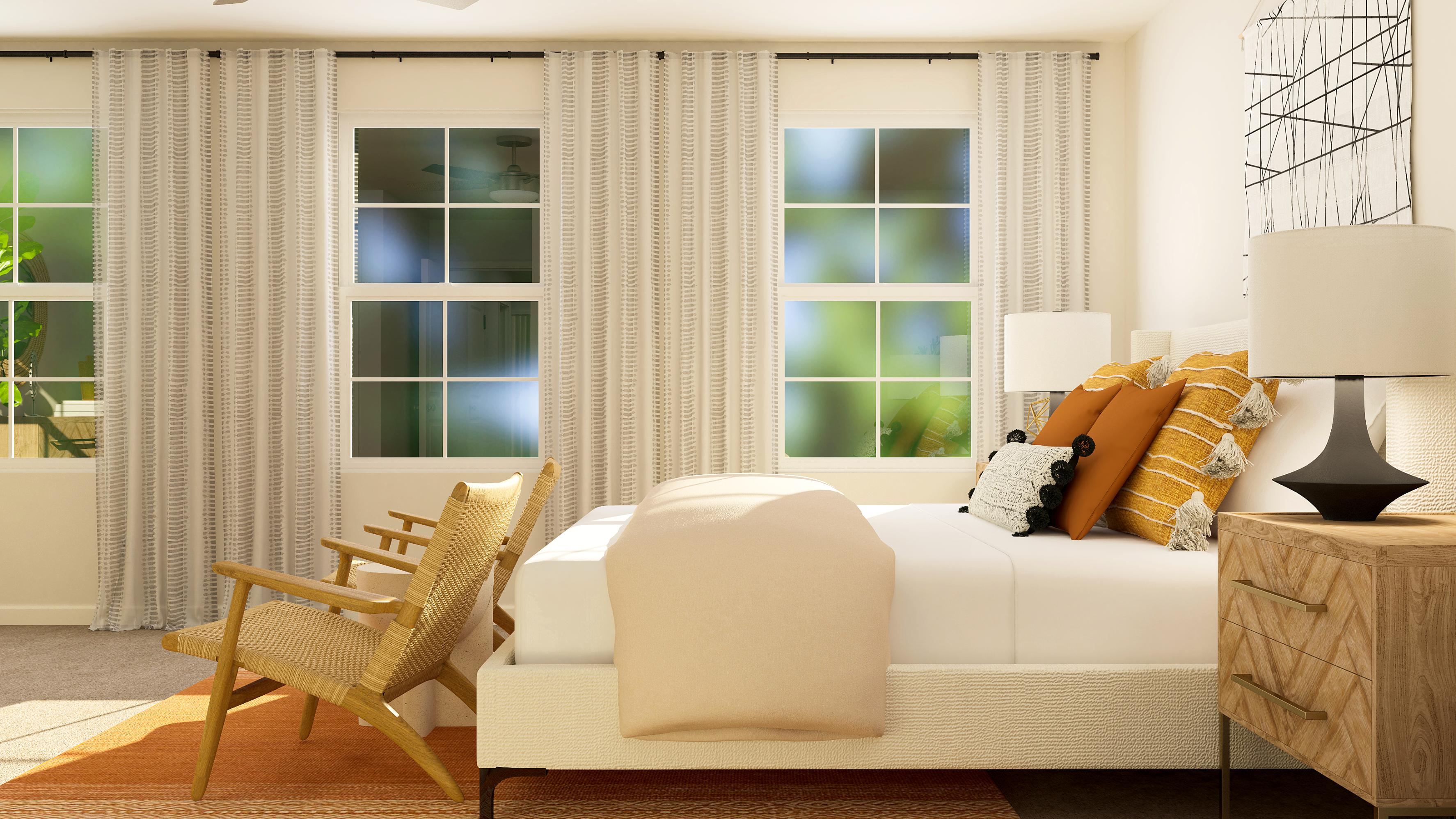 A white couch with a chair and a table in front of it.