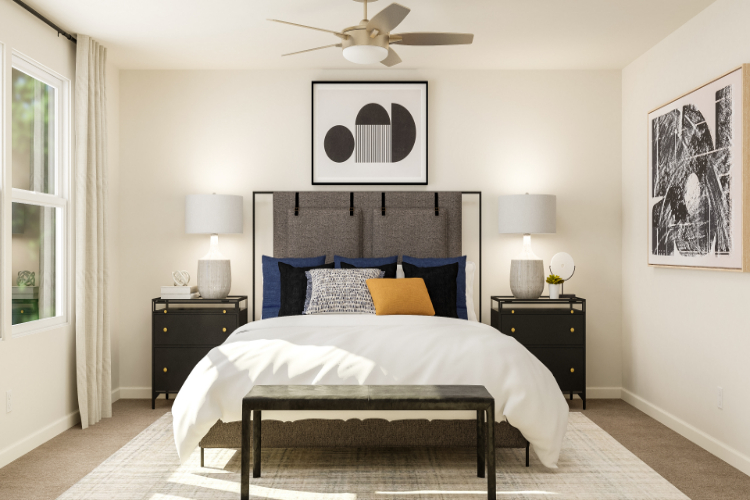 A bedroom with a bed and lamps.